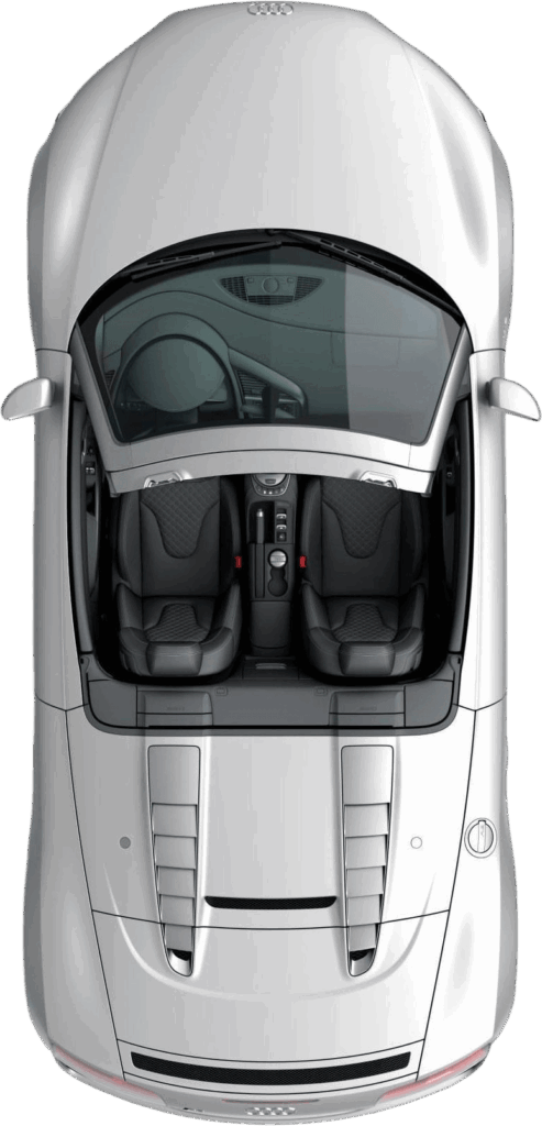 Top-down view of a silver sports car showing the interior with two seats, steering wheel, and center console visible through the open canopy area.