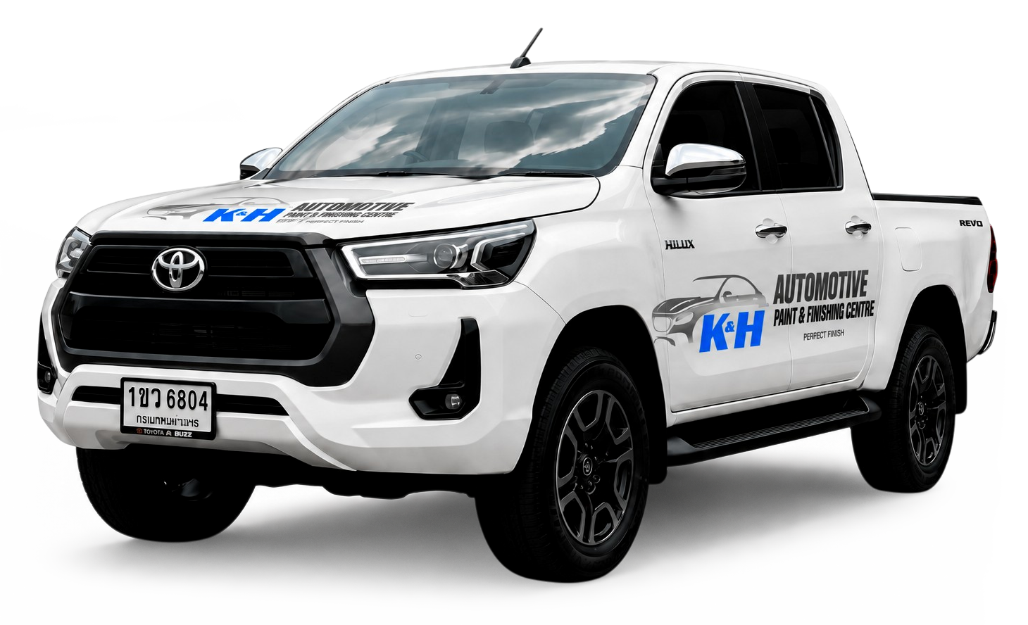 White Toyota Hilux pickup with KH Automotive branding and 'Automotive Paint & Finishing Centre' text on side; promotional vehicle image used for a service center.