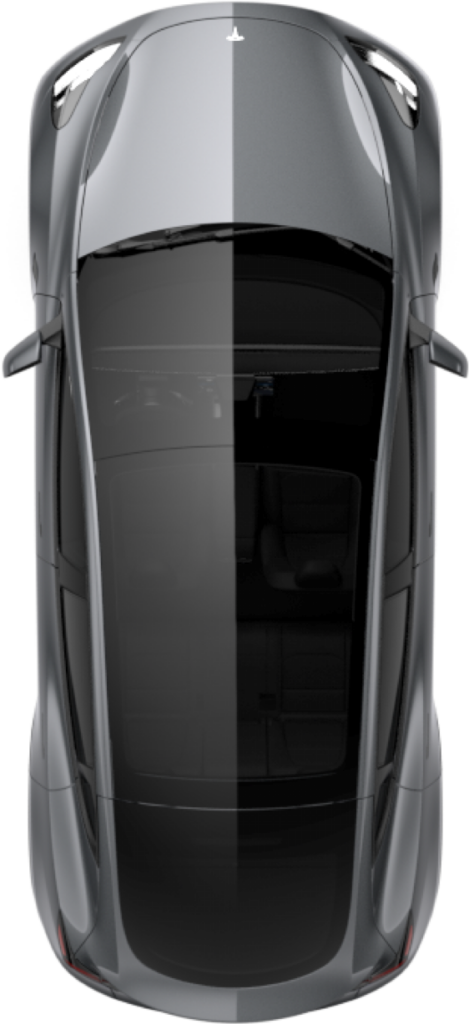 Top-down view of a gray sports car showing a split-color roof and interior seating visible through the glass sunroof/sheet metal panels.